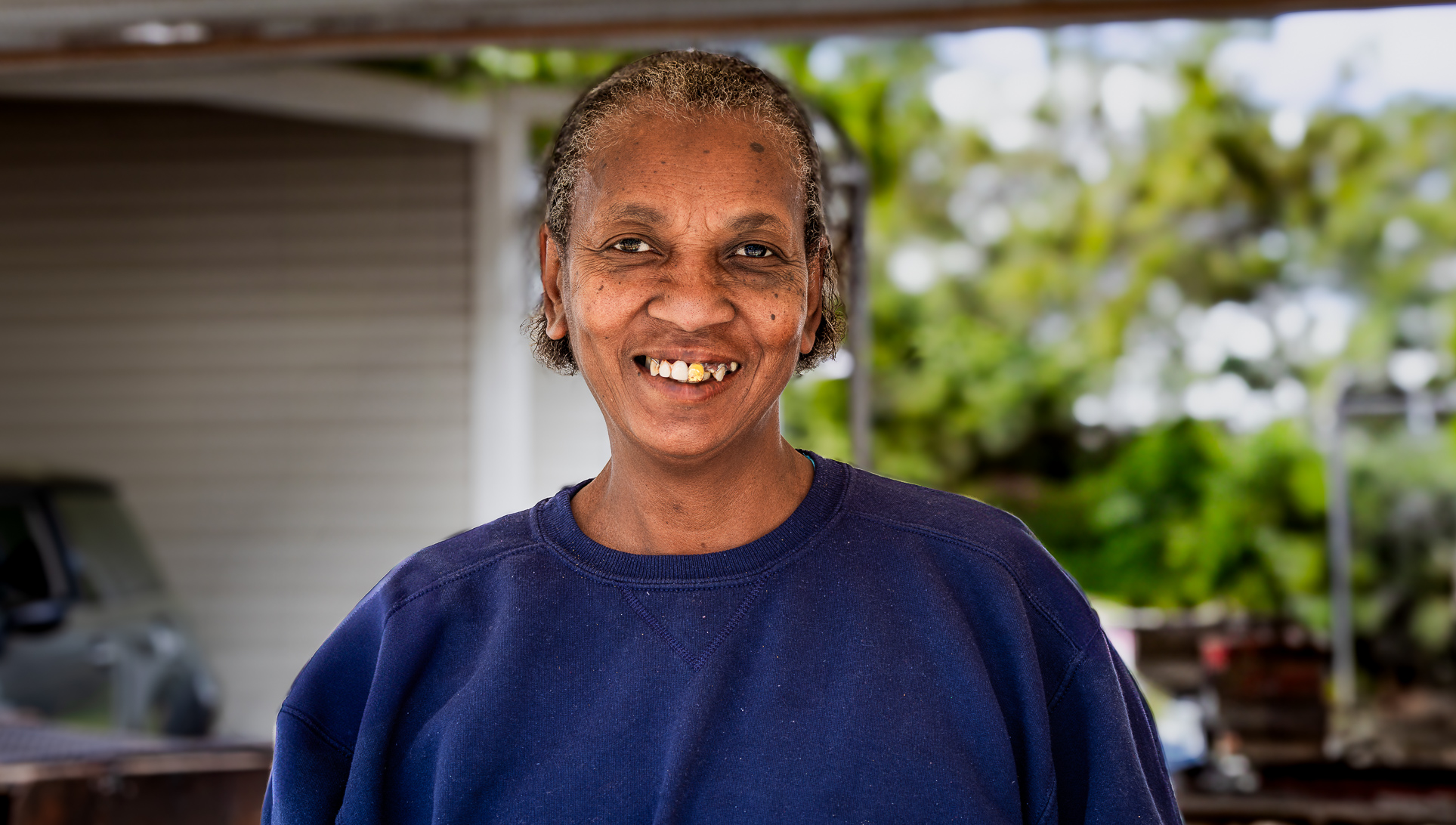 “African American woman from Cambridge, Maryland smiling naturally, showing her golden tooth in a relaxed lifestyle portrait